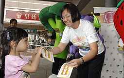 Dr Regina Ching distributing coupons